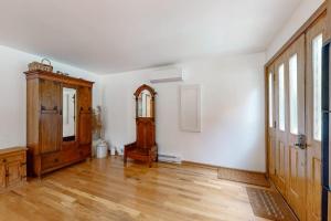an empty room with a wooden door and wooden floors at Steps from the Sand in Union Pier