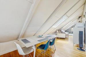 a dining room with a table and chairs in an attic at Monument View in Provincetown