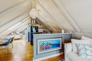 a living room with a couch and a tv at Monument View in Provincetown