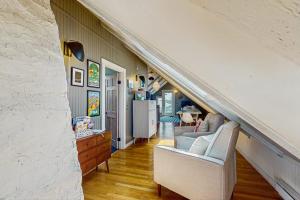 a living room with two chairs and a staircase at Monument View in Provincetown
