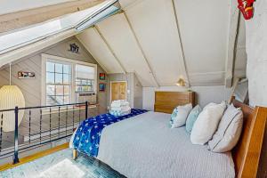 a bedroom with a large bed with blue and white pillows at Monument View in Provincetown +17 photos