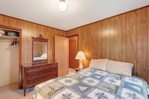 a bedroom with a bed and a dresser and a mirror at Walloon Lake Cottage in Boyne City +32 photos
