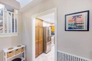 a kitchen with a refrigerator and a hallway at Lou n' Lil's in Glen Arbor