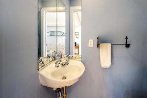 a bathroom with a sink and a mirror at Hammock Hideaway in Mashpee