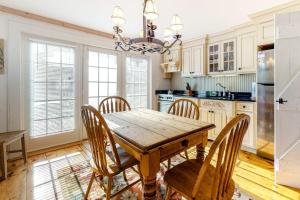 a kitchen with a wooden dining table and chairs at Hammock Hideaway in Mashpee
