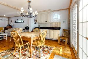 a kitchen and dining room with a wooden table and chairs at Hammock Hideaway in Mashpee +15 photos