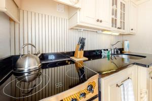 a kitchen with a sink and a pot on the counter at Hammock Hideaway in Mashpee