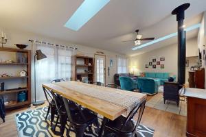 a living room with a wooden table and chairs at Four Bedrooms & a Beach in Lakeside