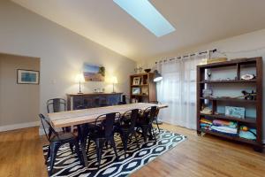 a dining room with a long table and chairs at Four Bedrooms & a Beach in Lakeside