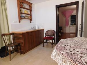 a bedroom with a sink and a table and chairs at Agroturystyka pod Czarną Sosną in Biały Ług