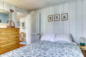 a bedroom with a bed and a wooden dresser at Sea la Vie in Harwich +4 photos