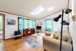 a living room with a couch and a table at Sea Glen Cottage in Oak Bluffs