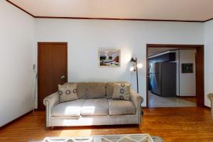 a living room with a couch and a refrigerator at Sea Glen Cottage in Oak Bluffs +23 photos