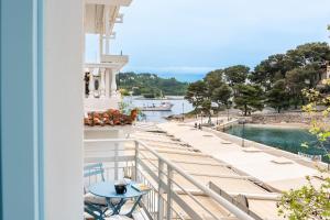 a balcony of a house with a view of the water at Olea Blue in Skiathos