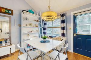 a dining room with a white table and chairs at Provincetown Waterfront Studio in Provincetown