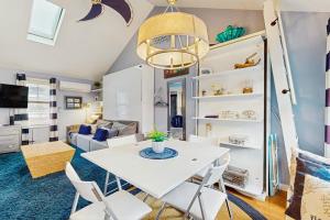 a living room with a white table and chairs at Provincetown Waterfront Studio in Provincetown