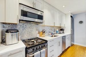 a kitchen with a stove and a microwave at Provincetown Waterfront Studio in Provincetown