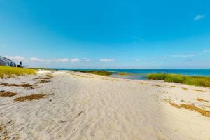 a sandy beach with the ocean in the background at Sea Coast Cottage in Barnstable