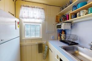 a small kitchen with a sink and a window at Sea Coast Cottage in Barnstable