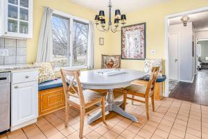 a kitchen with a table and chairs and a window at Birdie Bungalow in Saugatuck
