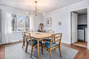 a dining room with a table and chairs at Birdie Bungalow in Saugatuck