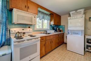 a kitchen with white appliances and wooden cabinets at Nauset Beach Dream in Orleans
