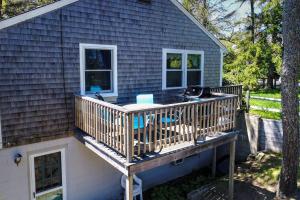 a house with a deck with a grill on it at Nauset Beach Dream in Orleans