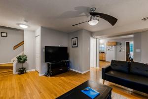 a living room with a black couch and a flat screen tv at Seafarer 7 in Ocean Pines