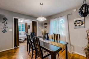 a dining room with a black table and chairs at Seafarer 7 in Ocean Pines +21 photos