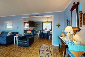 a living room with blue walls and a blue couch at Summer Get Away in Dennis Port