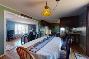 a dining room with a table with chairs and a light at Summer Get Away in Dennis Port +26 photos