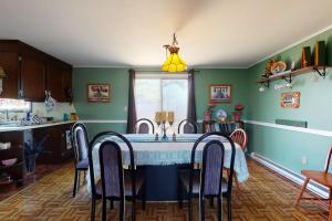 a dining room with a table and chairs in a kitchen at Summer Get Away in Dennis Port