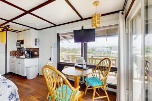 a kitchen and dining room with a table and chairs at The Pagoda Perch in North Truro