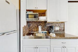 a kitchen with a sink and a microwave at The Pagoda Perch in North Truro