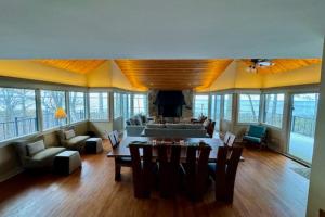 a living room with a couch and a table and chairs at Tally-Sun on the Bluff in Harbor Springs