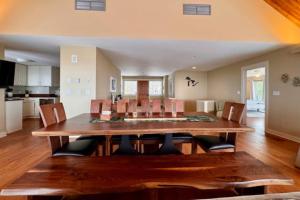 a dining room and kitchen with a wooden table and chairs at Tally-Sun on the Bluff in Harbor Springs +46 photos