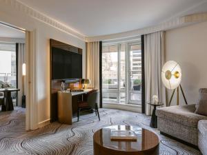 a living room with a couch and a desk at Sofitel New York in New York