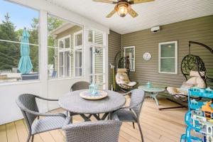 a patio with a table and chairs and a window at Appy Place in South Haven