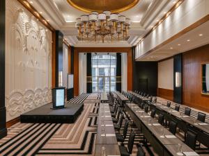 a conference room with chairs and a chandelier at Sofitel New York in New York