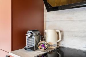 a kitchen counter with a toaster and a coffee maker at Casa Rheinblick - Apartment C in Basel