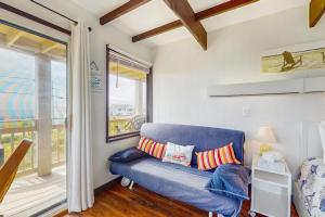 a blue couch in a room with a window at Seashore Escape in North Truro
