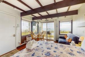 a bedroom with a bed and a living room at Seashore Escape in North Truro