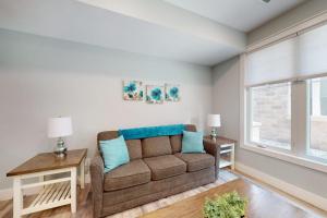 a living room with a couch and a window at Cozy TC Bay Condo in Traverse City