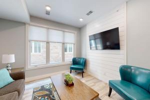 a living room with a couch and a tv at Cozy TC Bay Condo in Traverse City