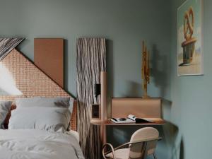 a bedroom with a bed and a table and a chair at TRIBE Strasbourg Centre Gare in Strasbourg