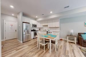 a kitchen and dining room with a table and chairs at Cozy TC Bay Condo in Traverse City +19 photos