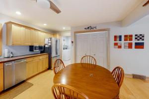 a kitchen with a wooden table and chairs in it at Absolute Leelanau in Glen Arbor