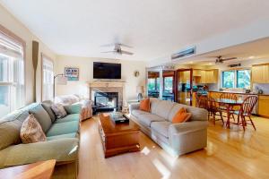 a living room with a couch and a table at Absolute Leelanau in Glen Arbor