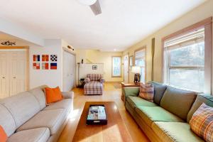 a living room with a couch and a table at Absolute Leelanau in Glen Arbor