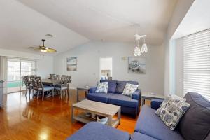 a living room with a blue couch and a table at Rotonda Getaway in Rotunda-West
